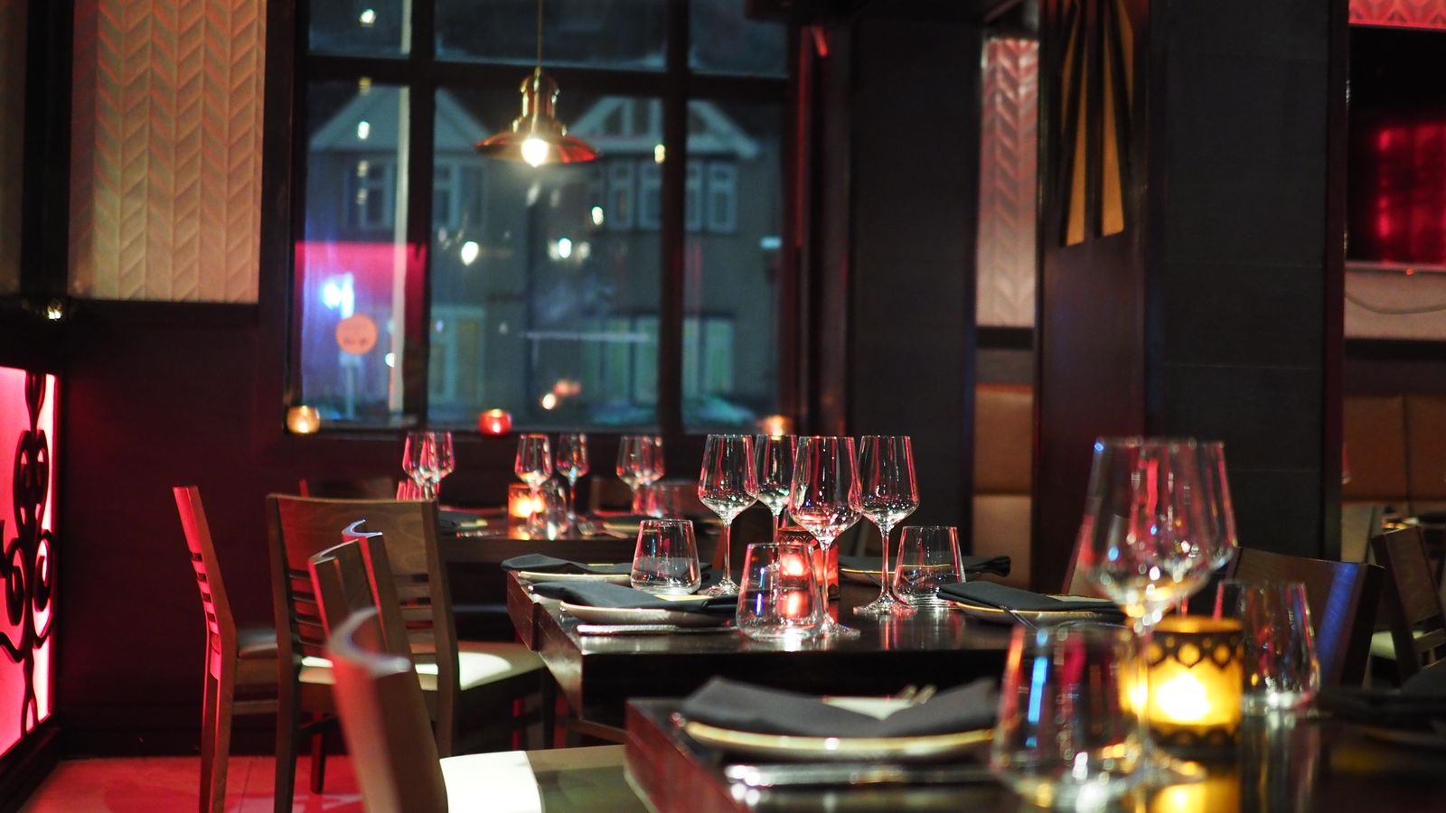 The candlelit dining room set for service