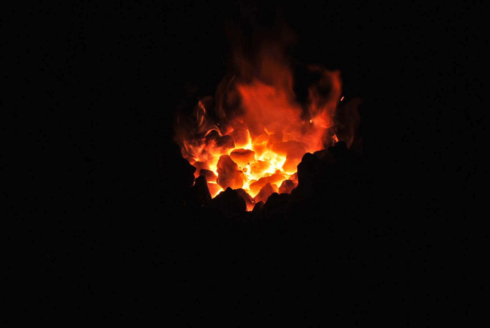 A low bed of embers glowing in the dark