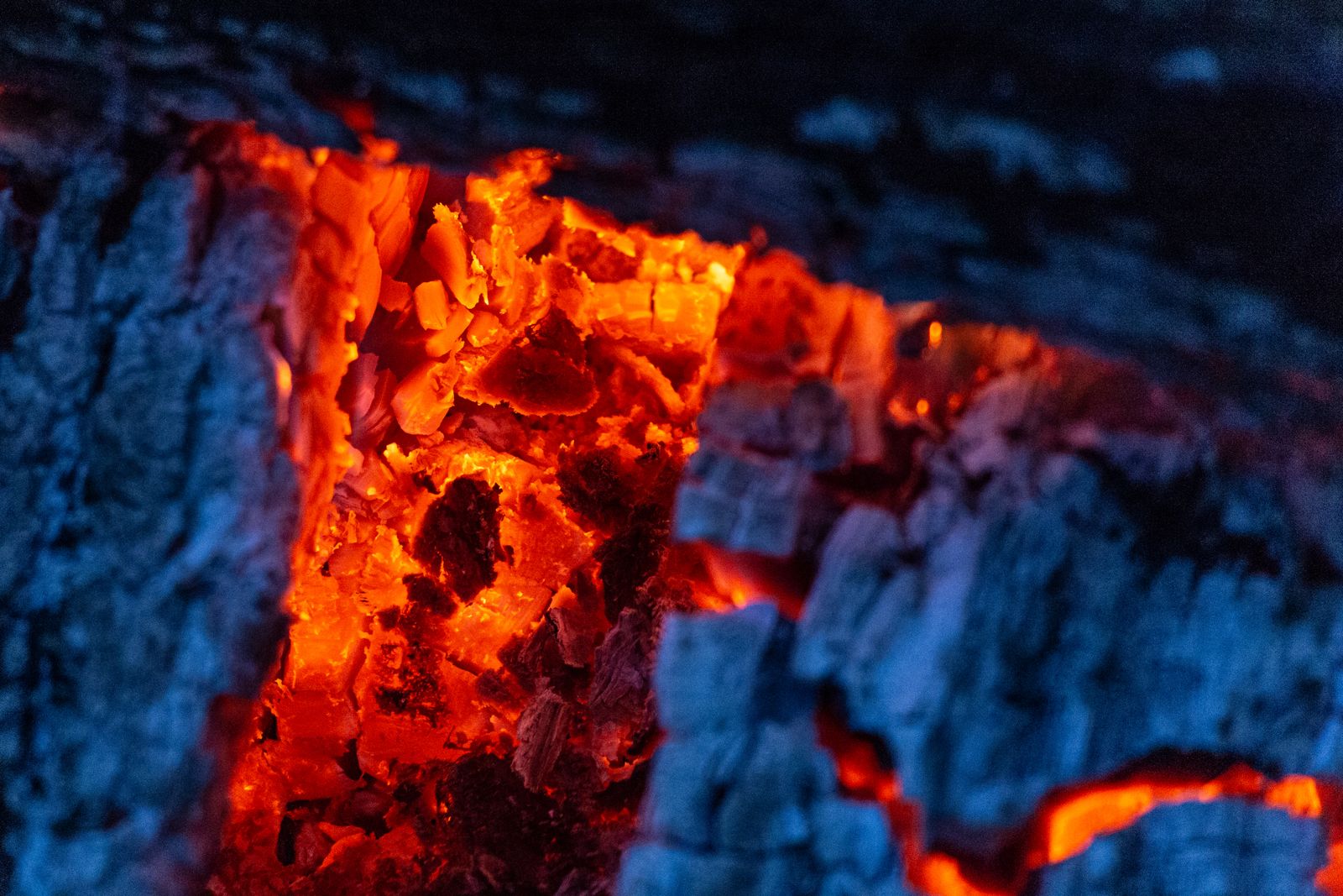 Charred oak logs glowing deep orange in the hearth