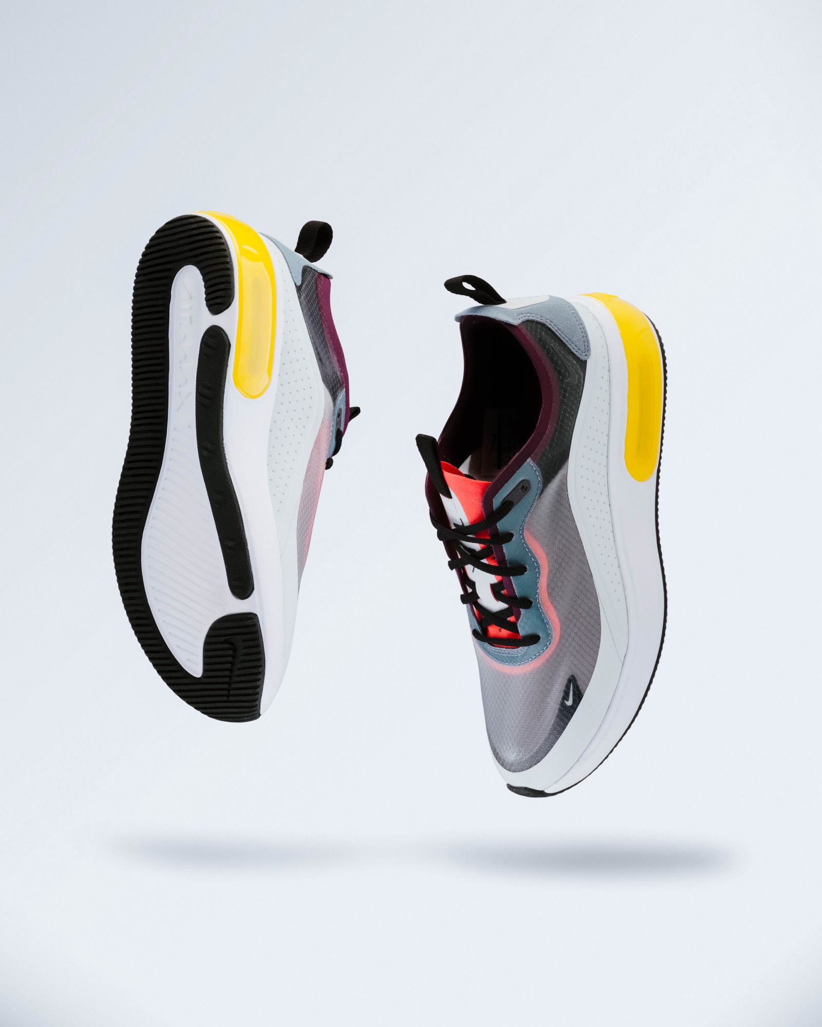 Floating mesh sneakers on grey studio ground