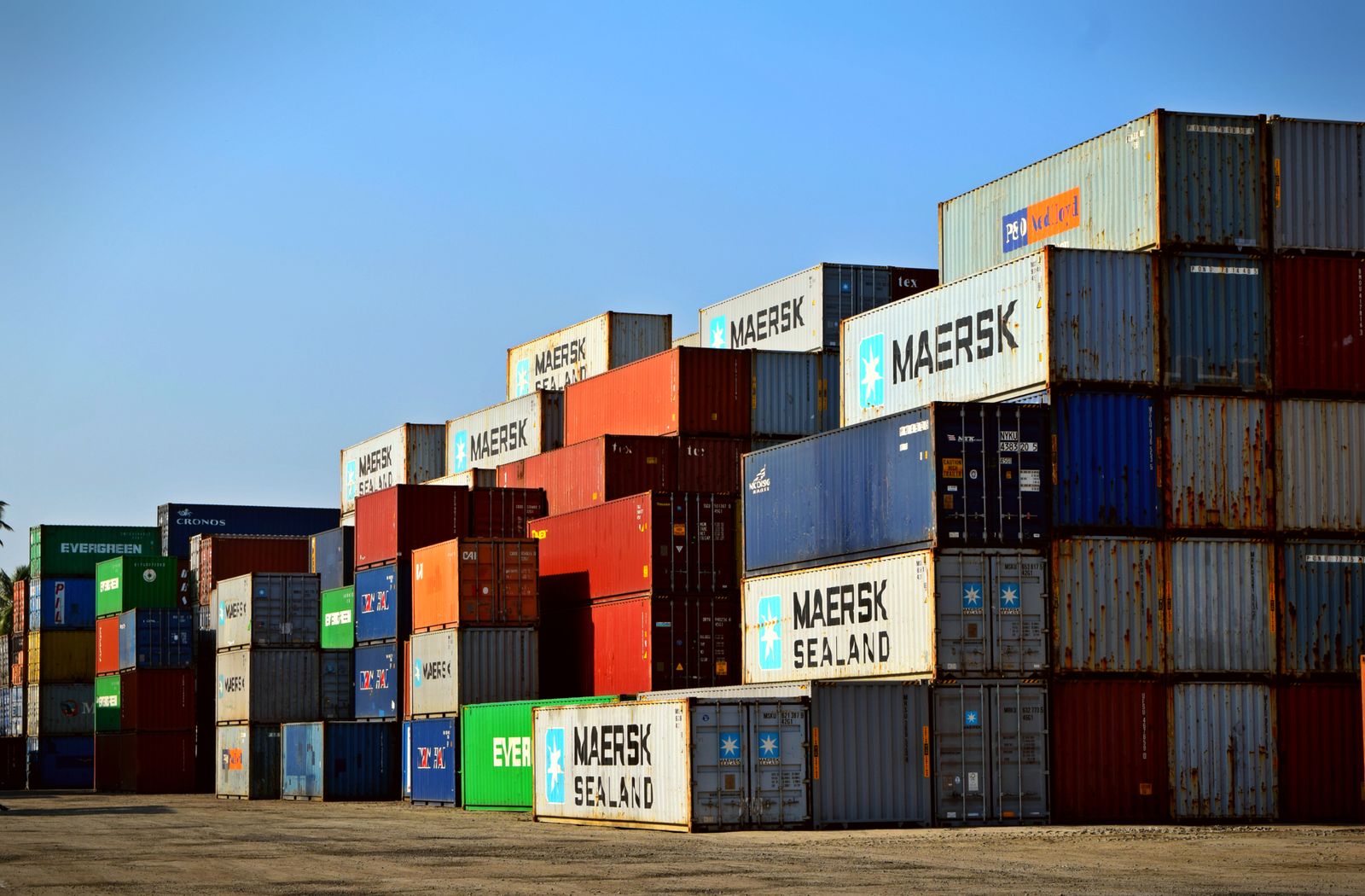 Stacked shipping containers at logistics yard