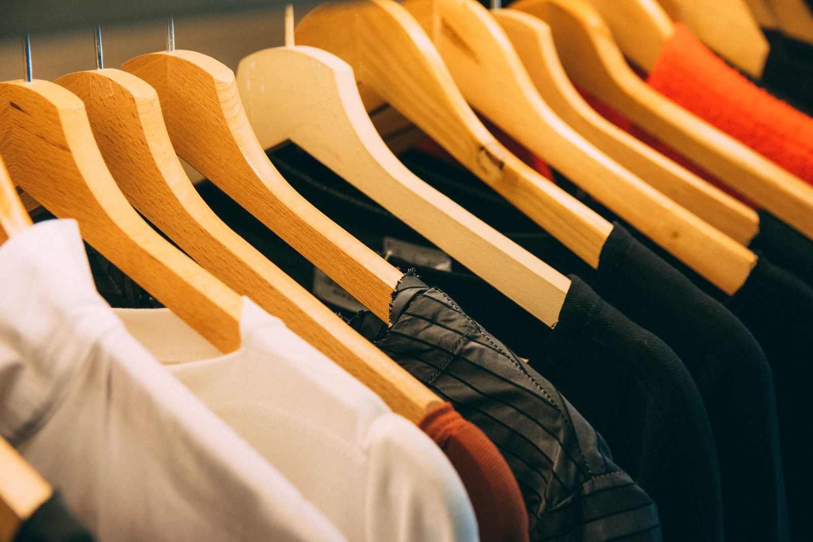 Elegant clothing on wooden hangers