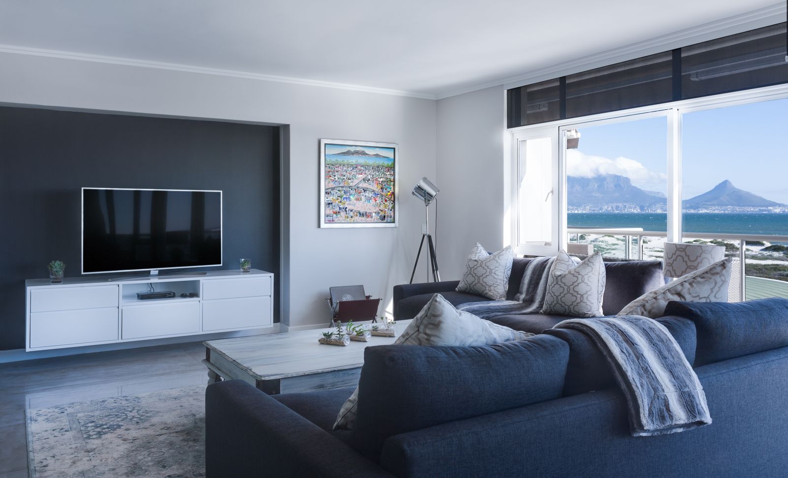 Modern living room overlooking coastal mountains